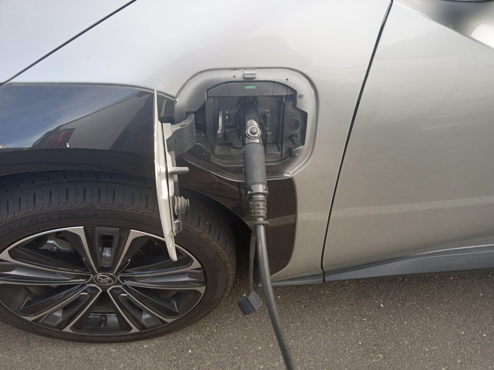 J1772 Level 2 charging connector plugged into a Toyota EV charge port